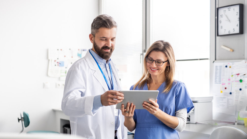 Dentist going over a case with a nurse